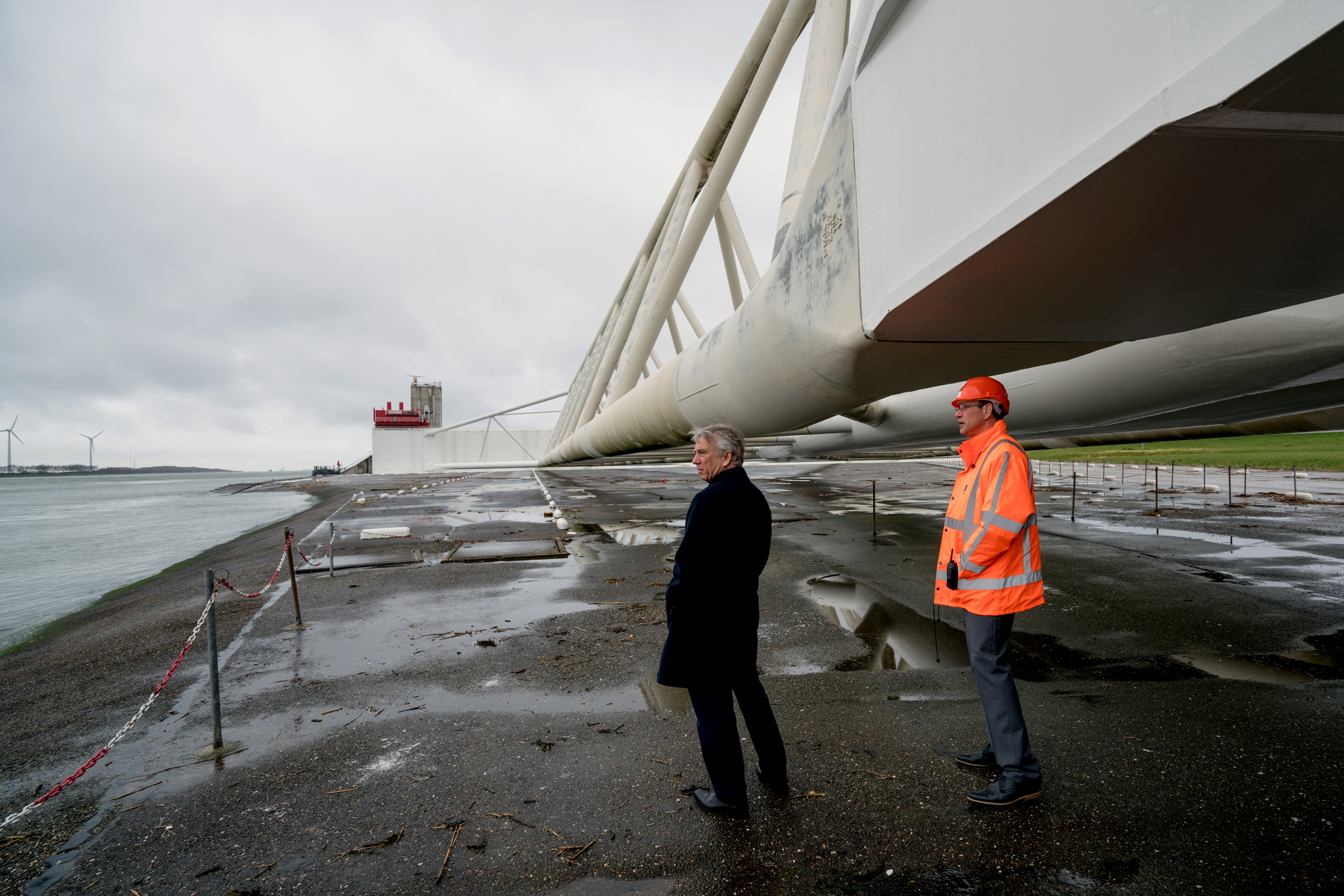 Piet Dircke (left) looks across the Nieuwe Waterweg from beneath one of the giant arms of the Maeslantkering storm surge barrier.