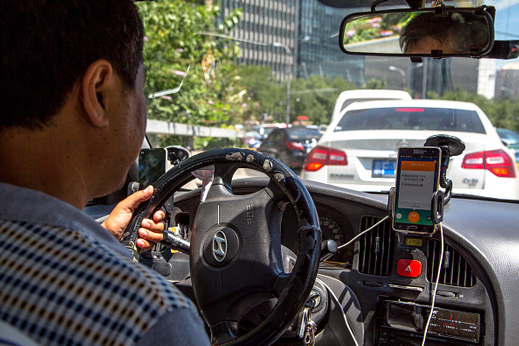 In China, drivers for local firm Didi Kuaidi and Uber both compete with traditional taxi drivers.