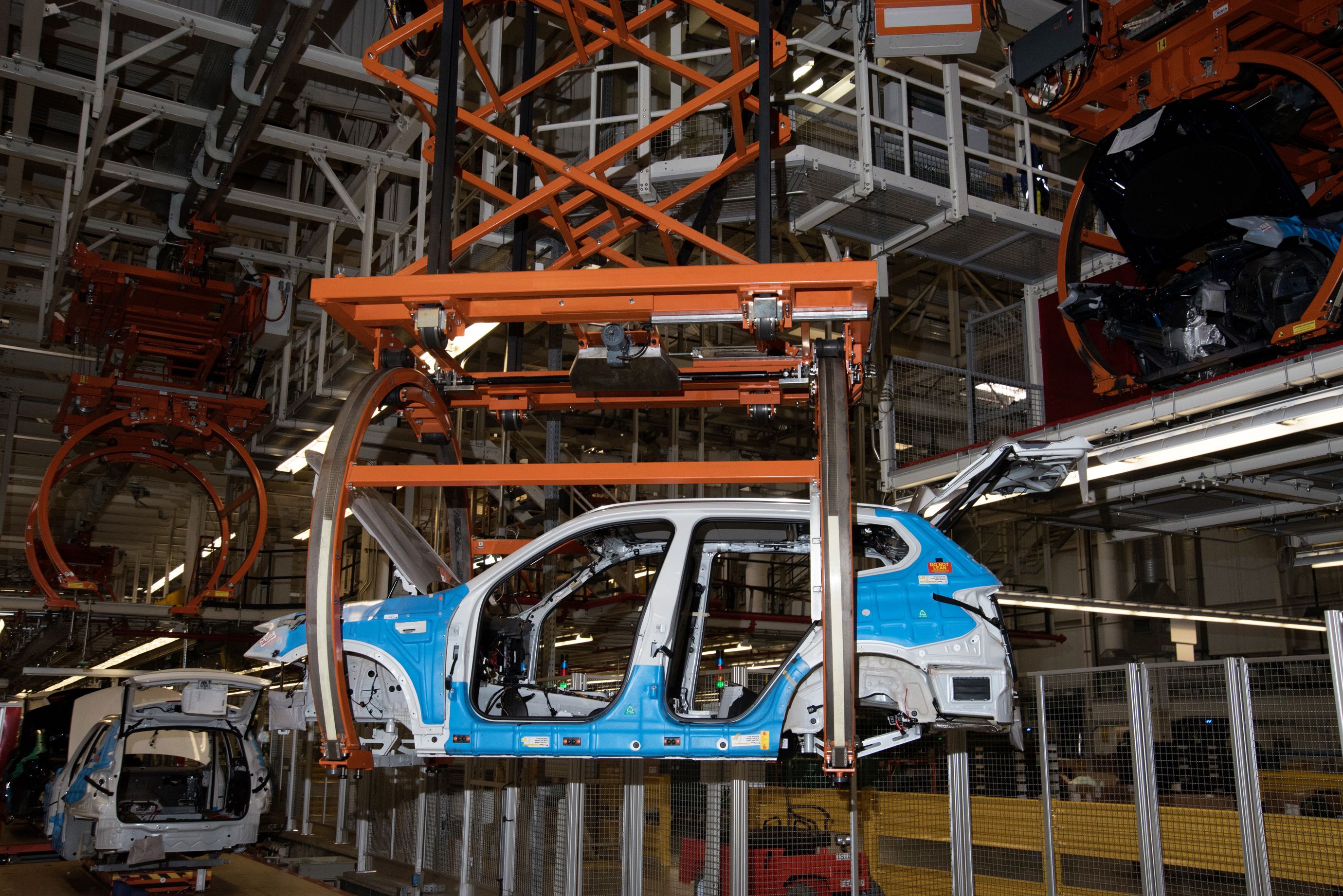 Cars are transported along the assembly line on a conveyor system. (7 of 7)