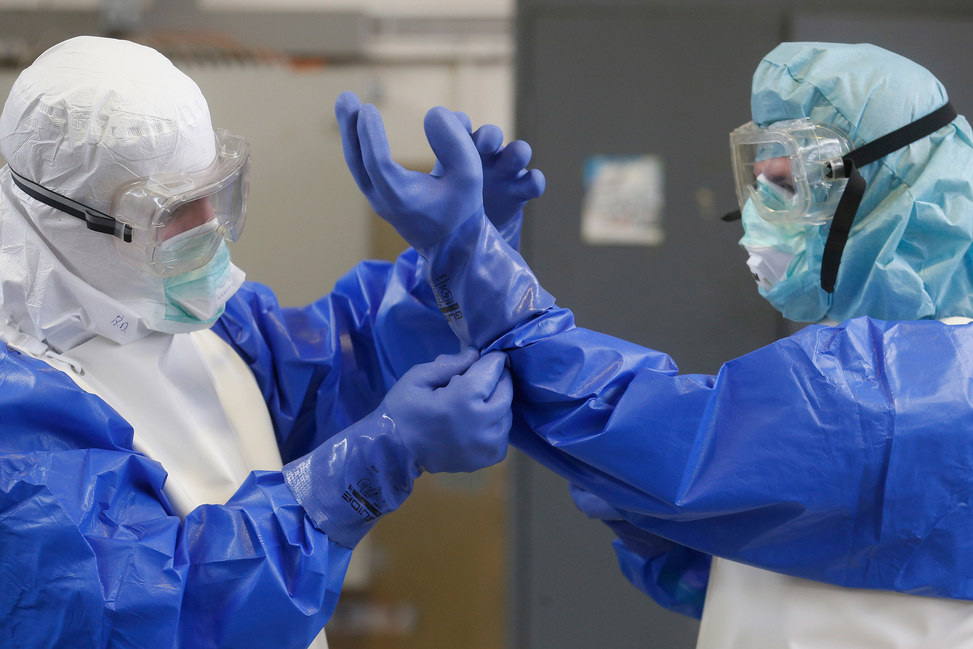 German Red Cross volunteers put on isolation suits while training to respond to Ebola virus in October 2014.