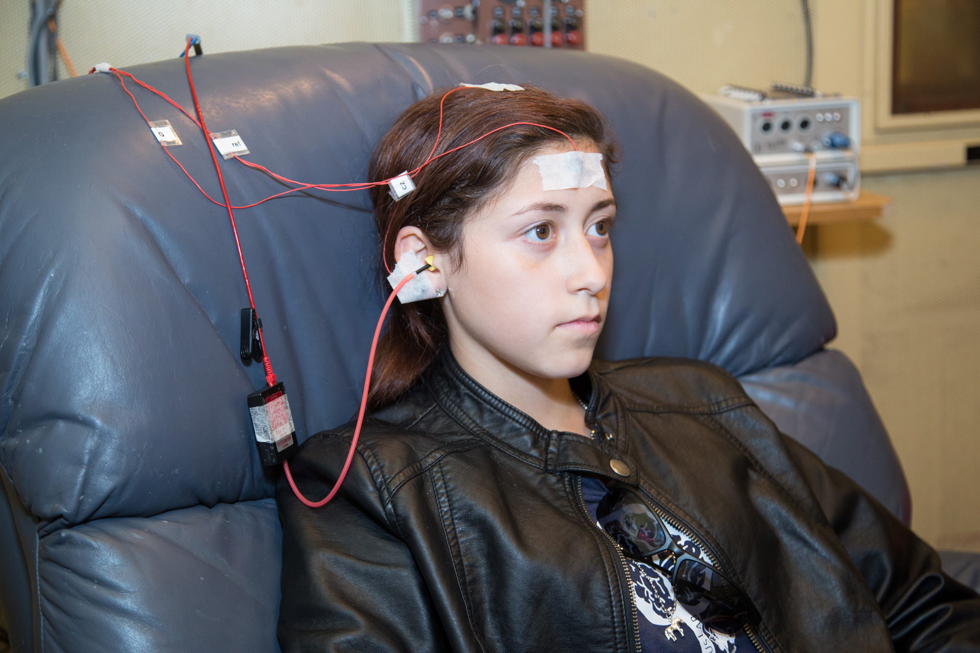 In a study at Northwestern University, a boy listens to a series of sounds while electrodes measure his brain activity to help diagnose a concussion.