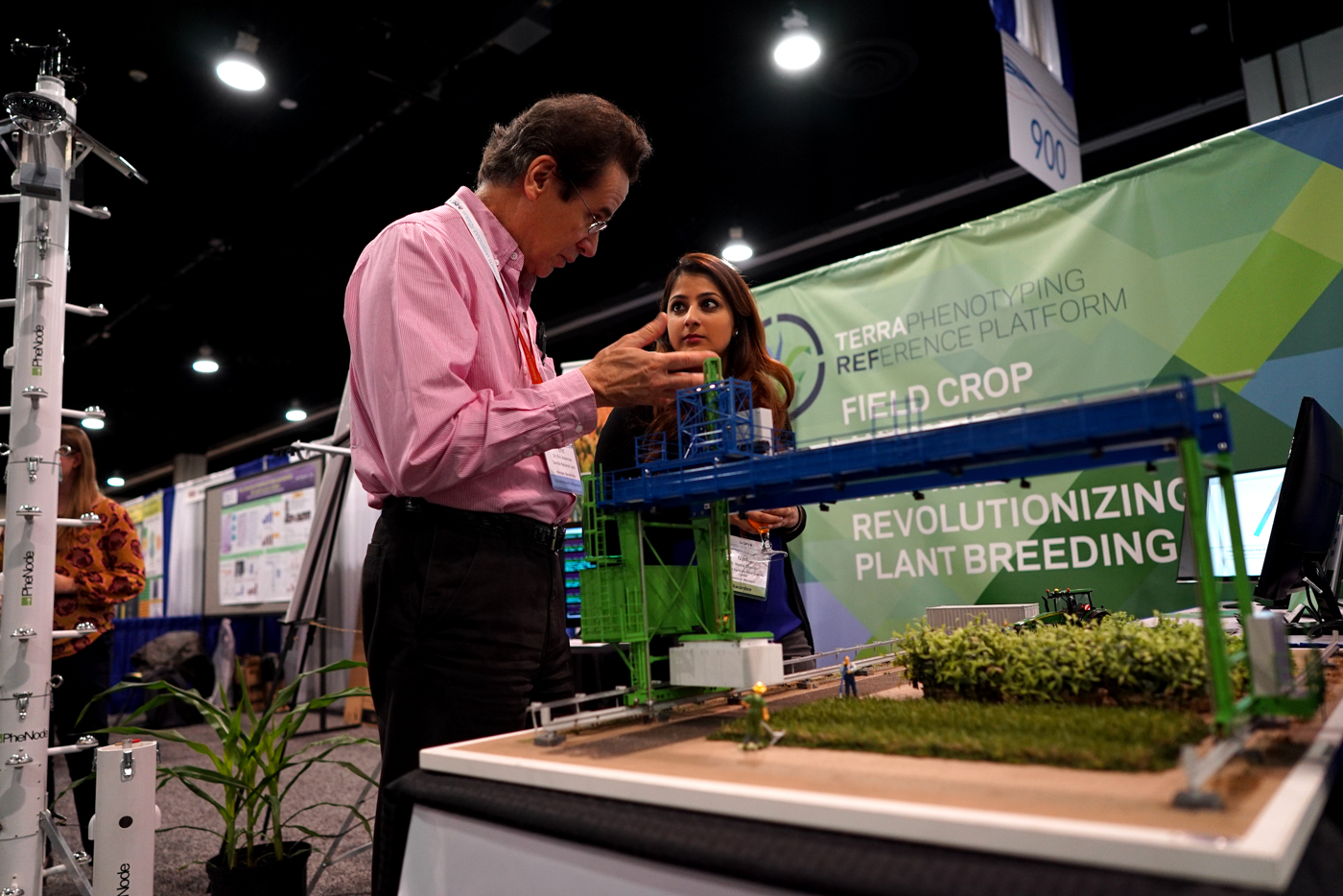 Attendees of the ARPA-E Energy Innovation Summit look over the model of the TERRA-REF robotic field scanning system, which continually collects crop data like carbon uptake and water use.