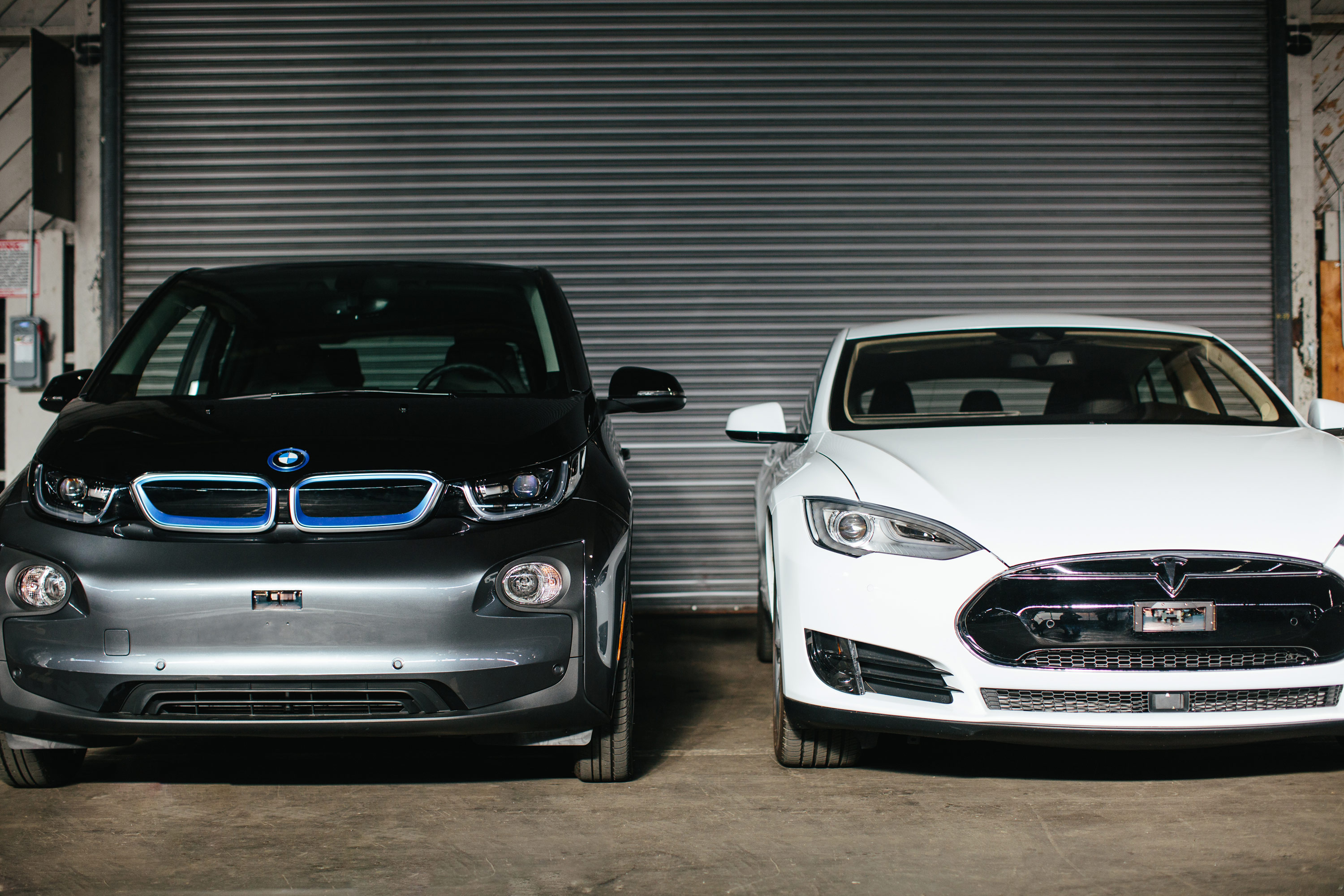 Luminar sensors integrated into the fenders of BMW and Tesla vehicles.