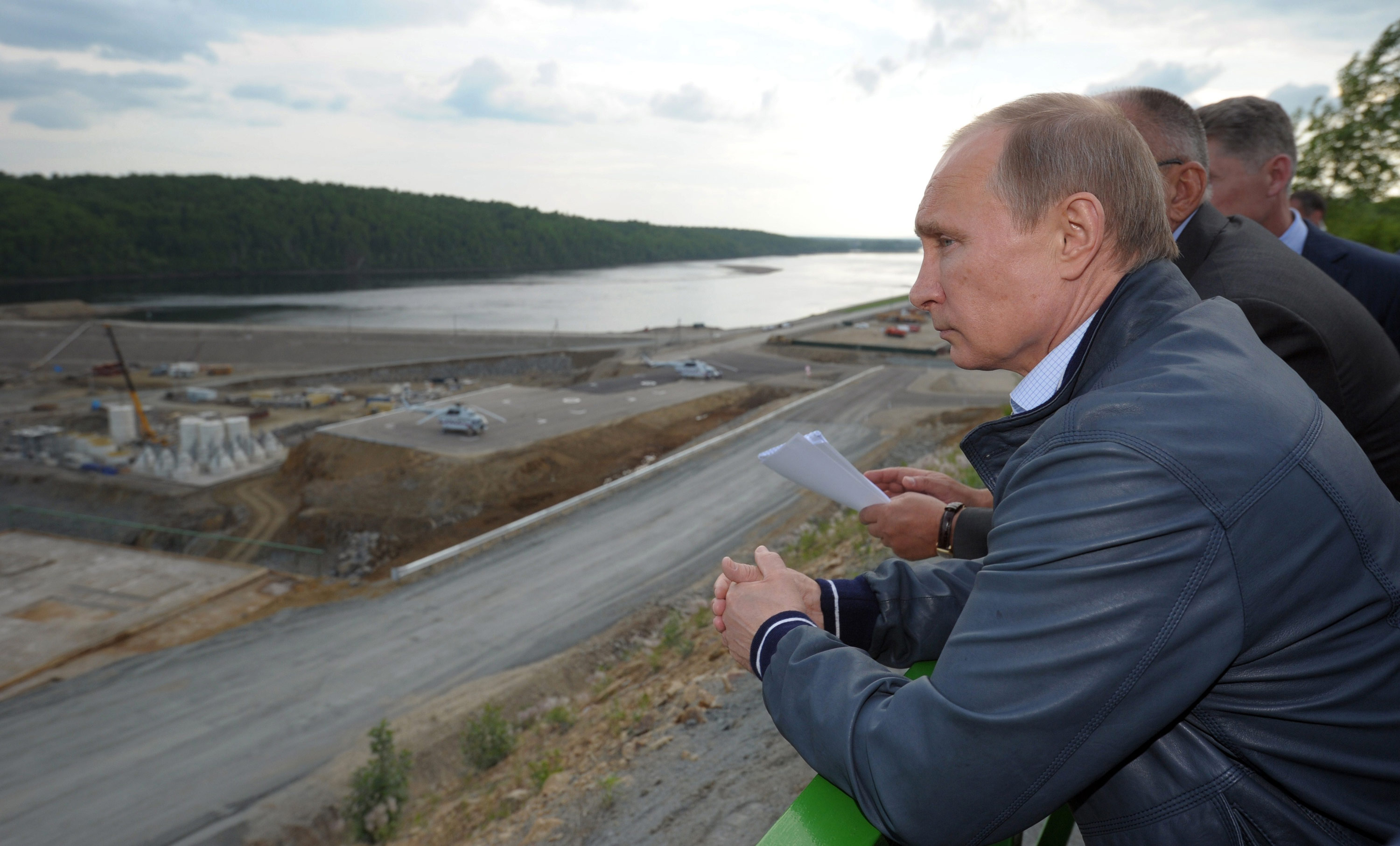 Russian president Vladimir Putin surveys the construction of a hydroelectric facility in Eastern Russia.