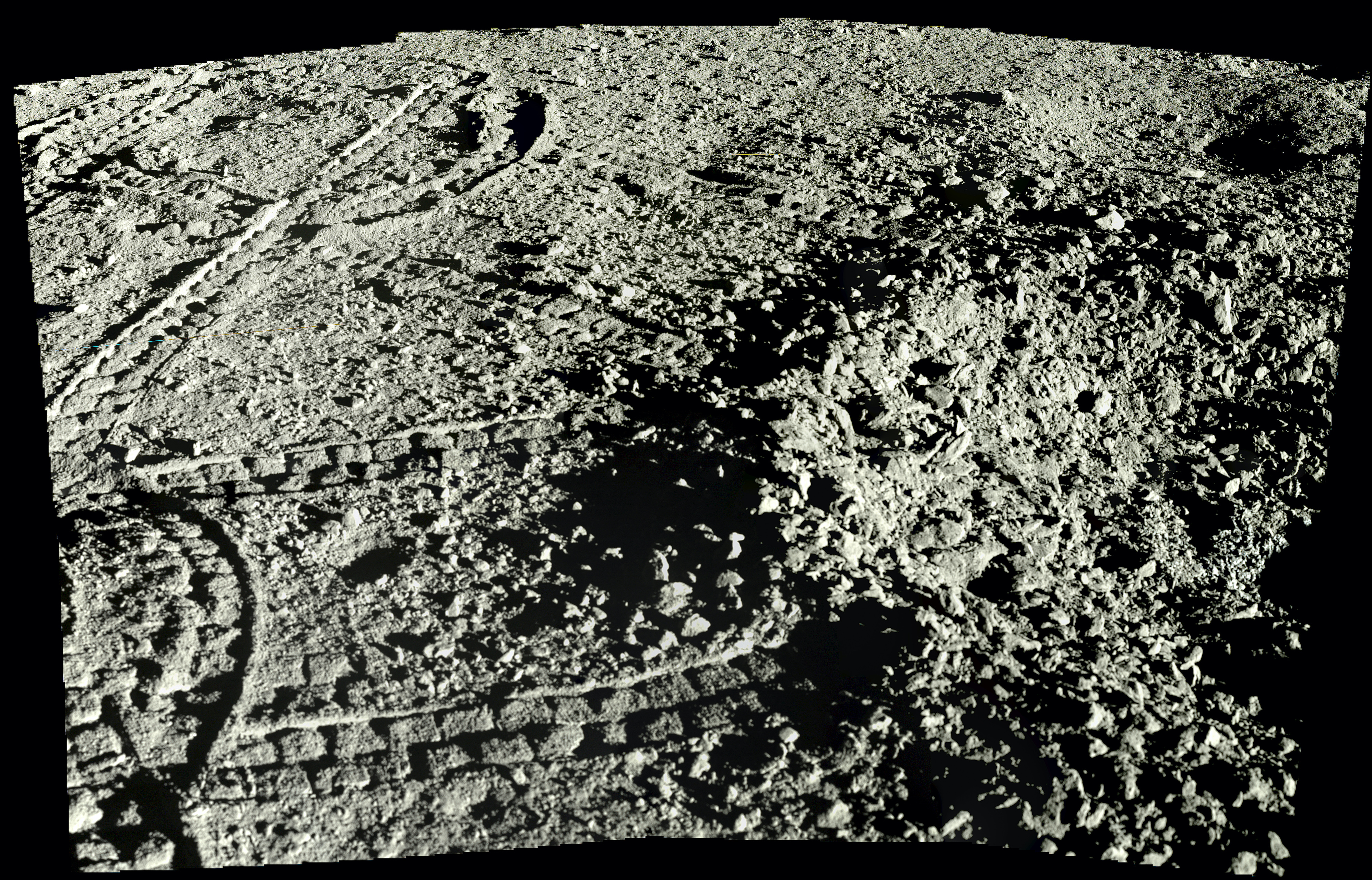 An up-close view of the lunar regolith from Yutu-2. You can see the rover's tracks in the soil.