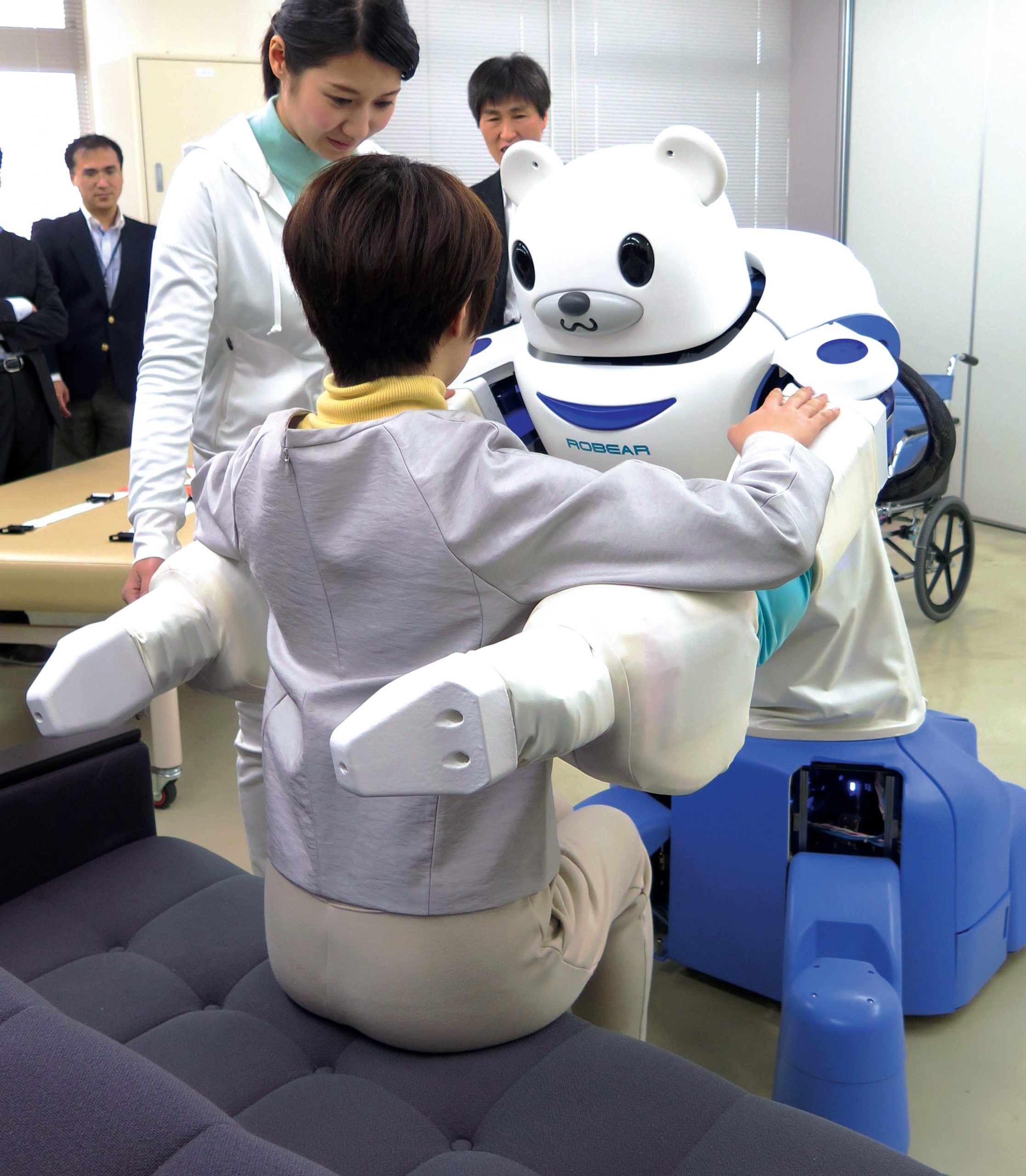 Robear poised to lift a person during a press demonstration.